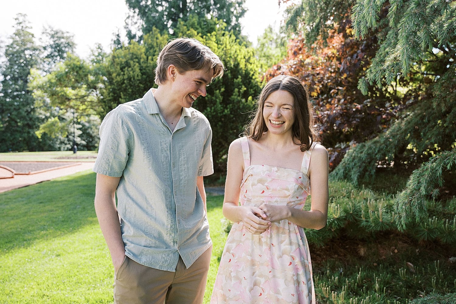 woman giggles next to her man in garden for wandering session