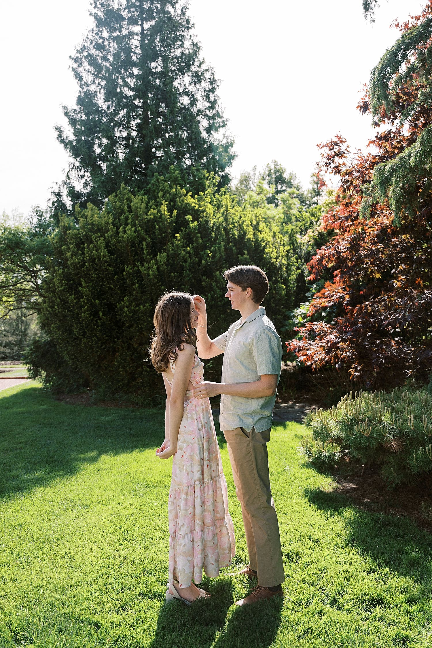 fiance gently brushes lady's hair out of her face by Camille Meers Photography 