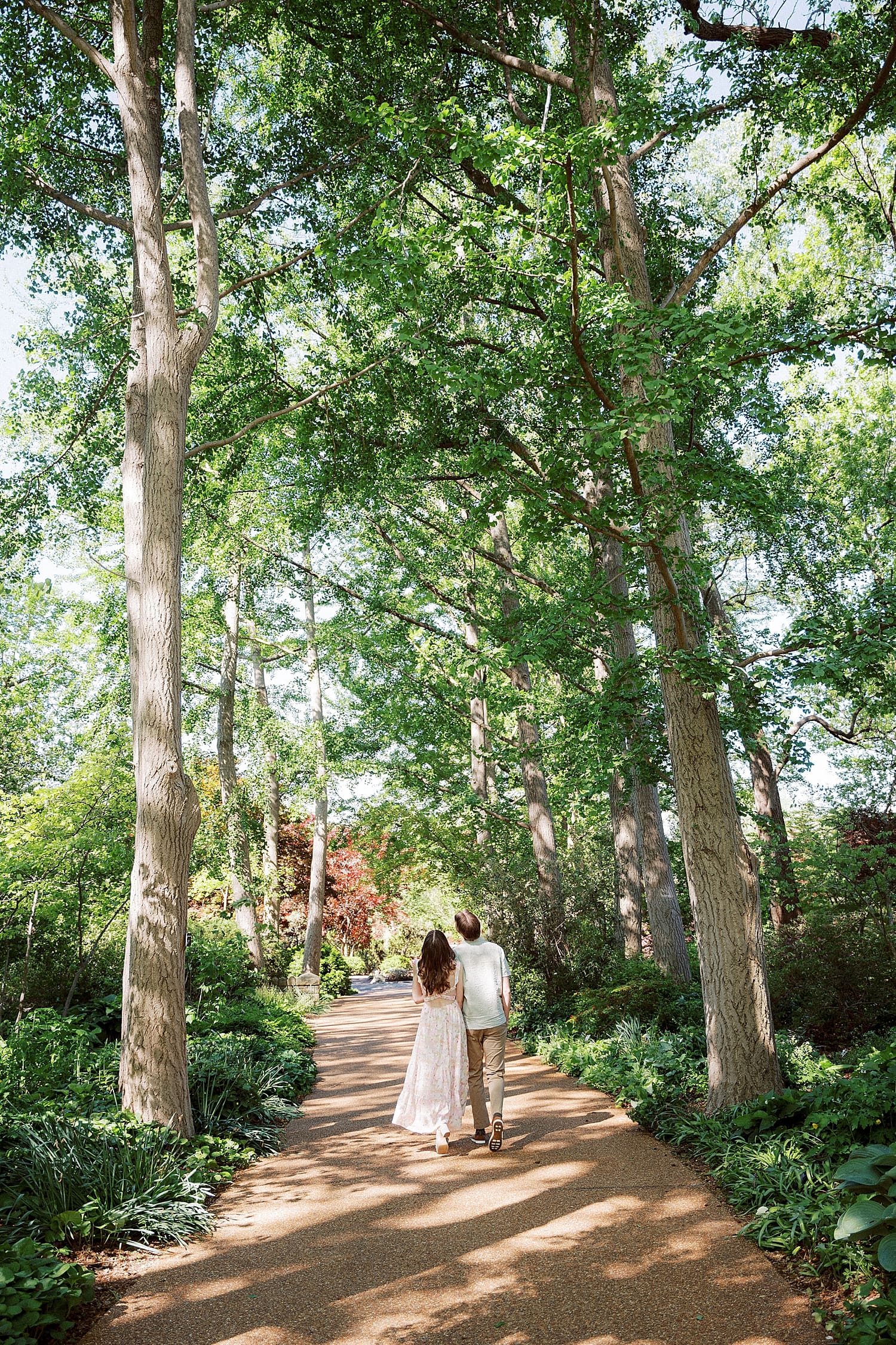 man and woman walk down a path together for wandering session