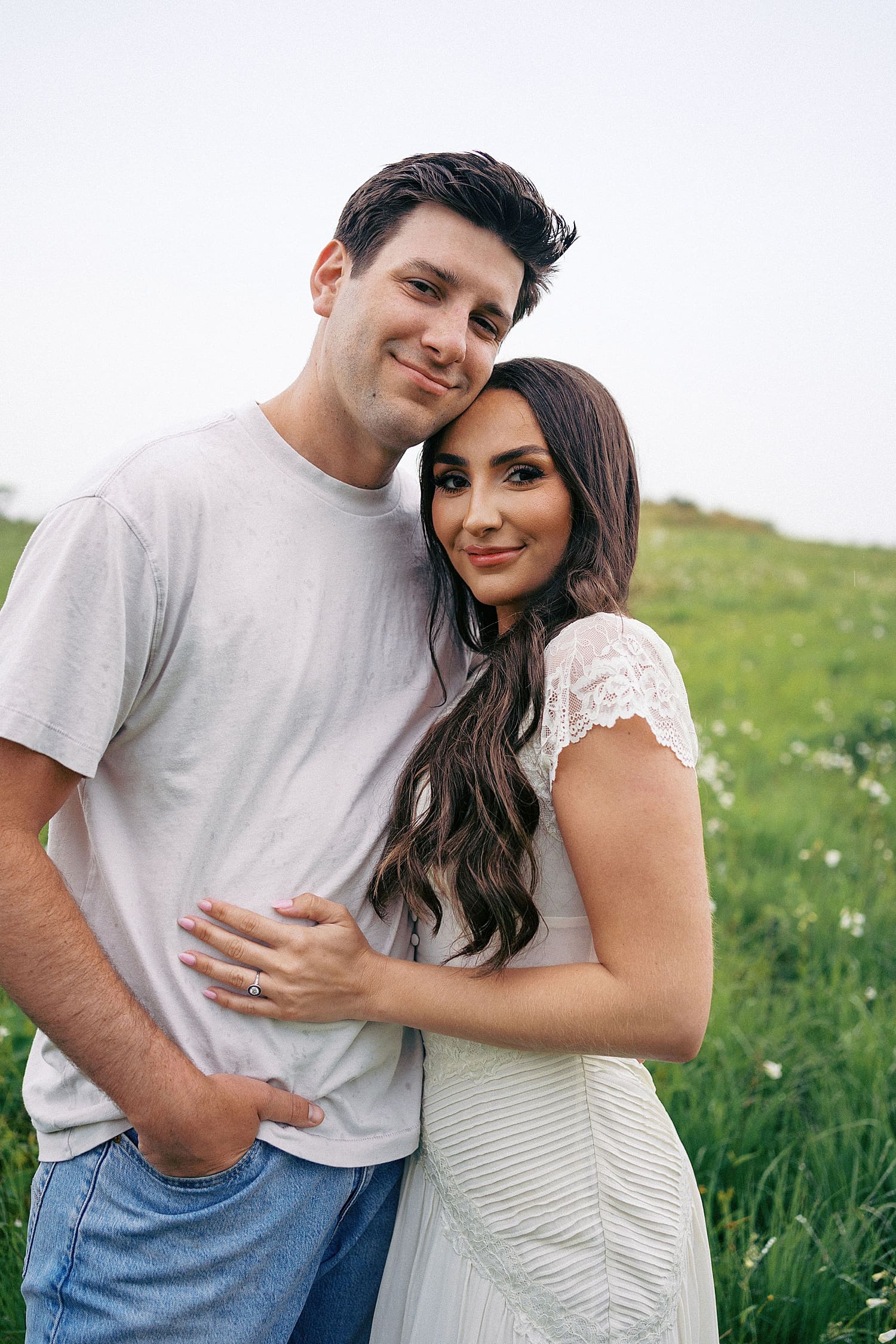 brunette man and woman hug after wondering what if it rains on your engagement session