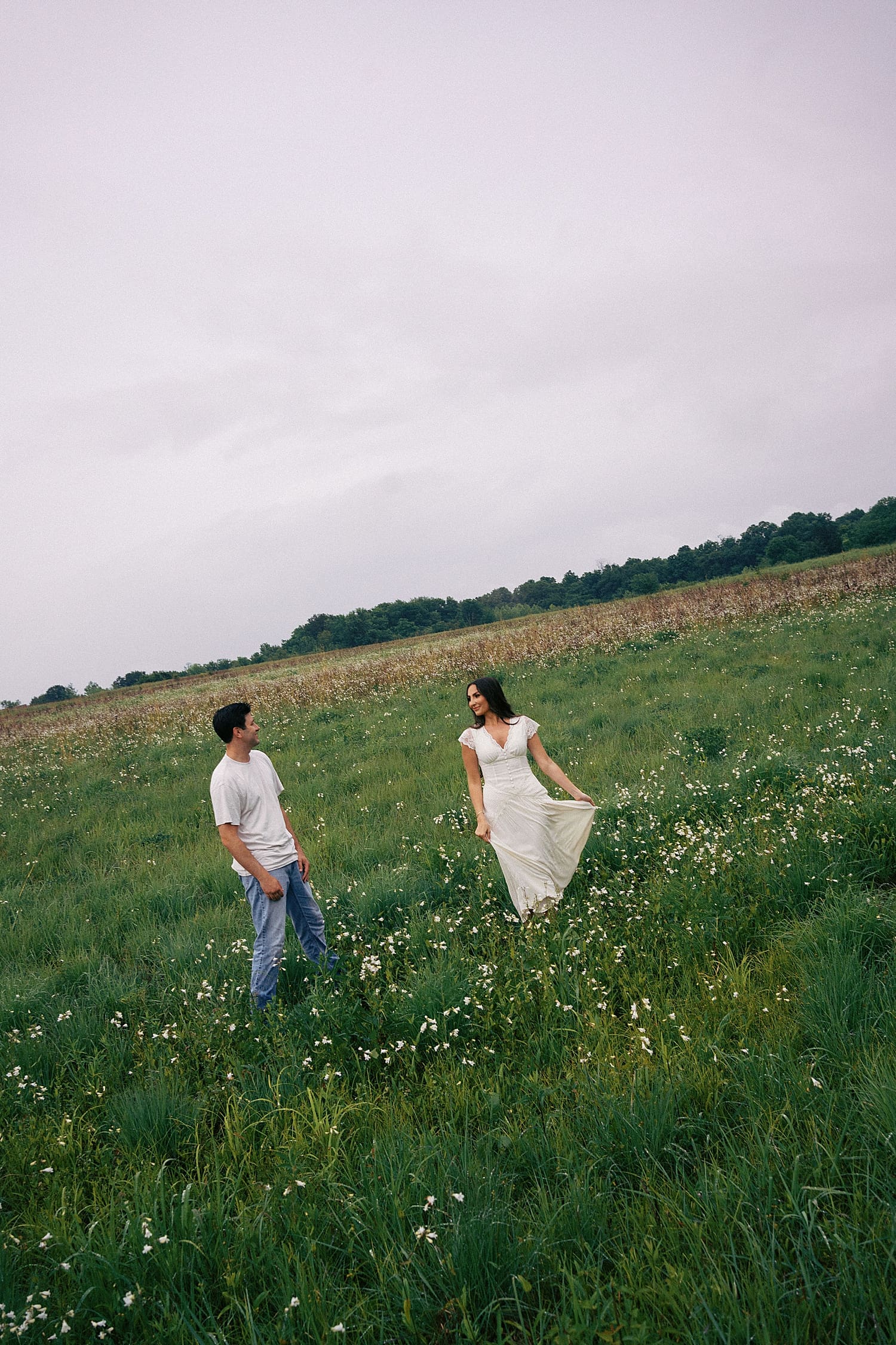 bride and groom dance in the flowers wondering what if it rains on your engagement session