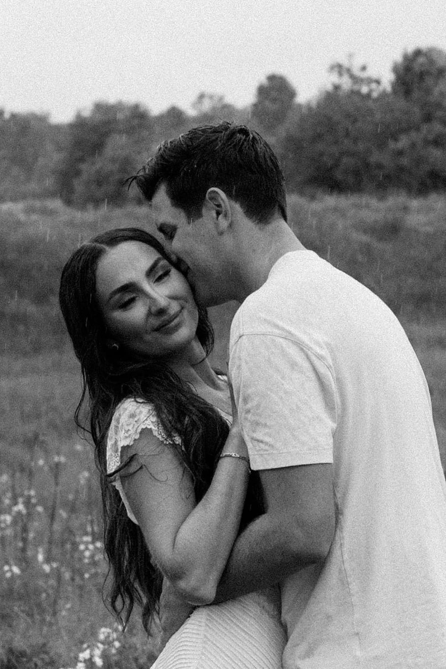 groom holds his wife-to-be closely and kisses her cheek by Camille Meers Photography