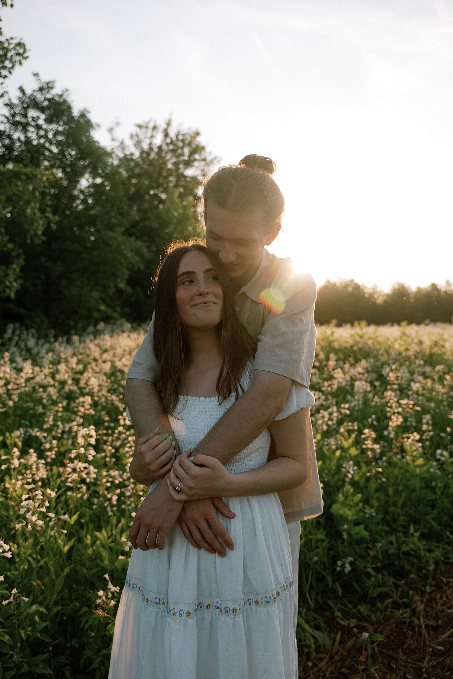 groom leans over to hold his wife-to-be by Camille Meers Photography