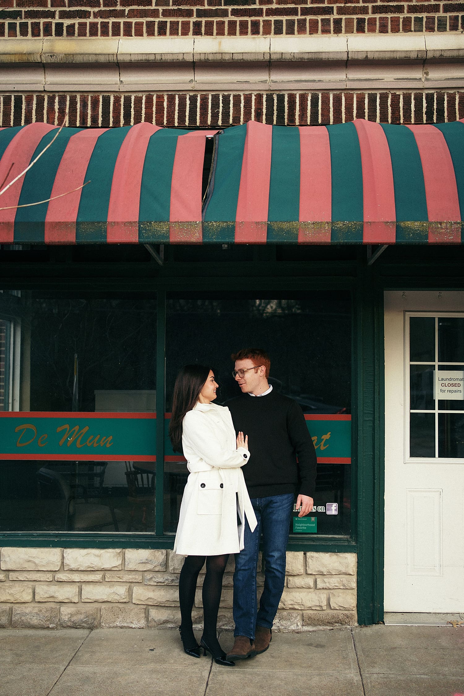 man and woman stand under awning on street by St. Louis Wedding Photographer