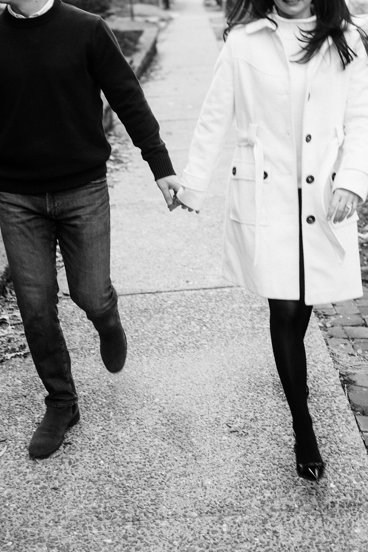 couple walks hand in hand down the sidewalk by St. Louis Wedding Photographer