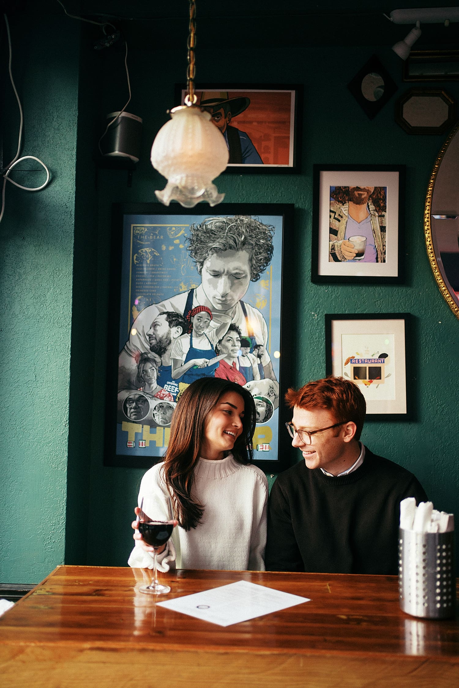 engaged couple sits at hightop table showing your engagement session should happen where you live
