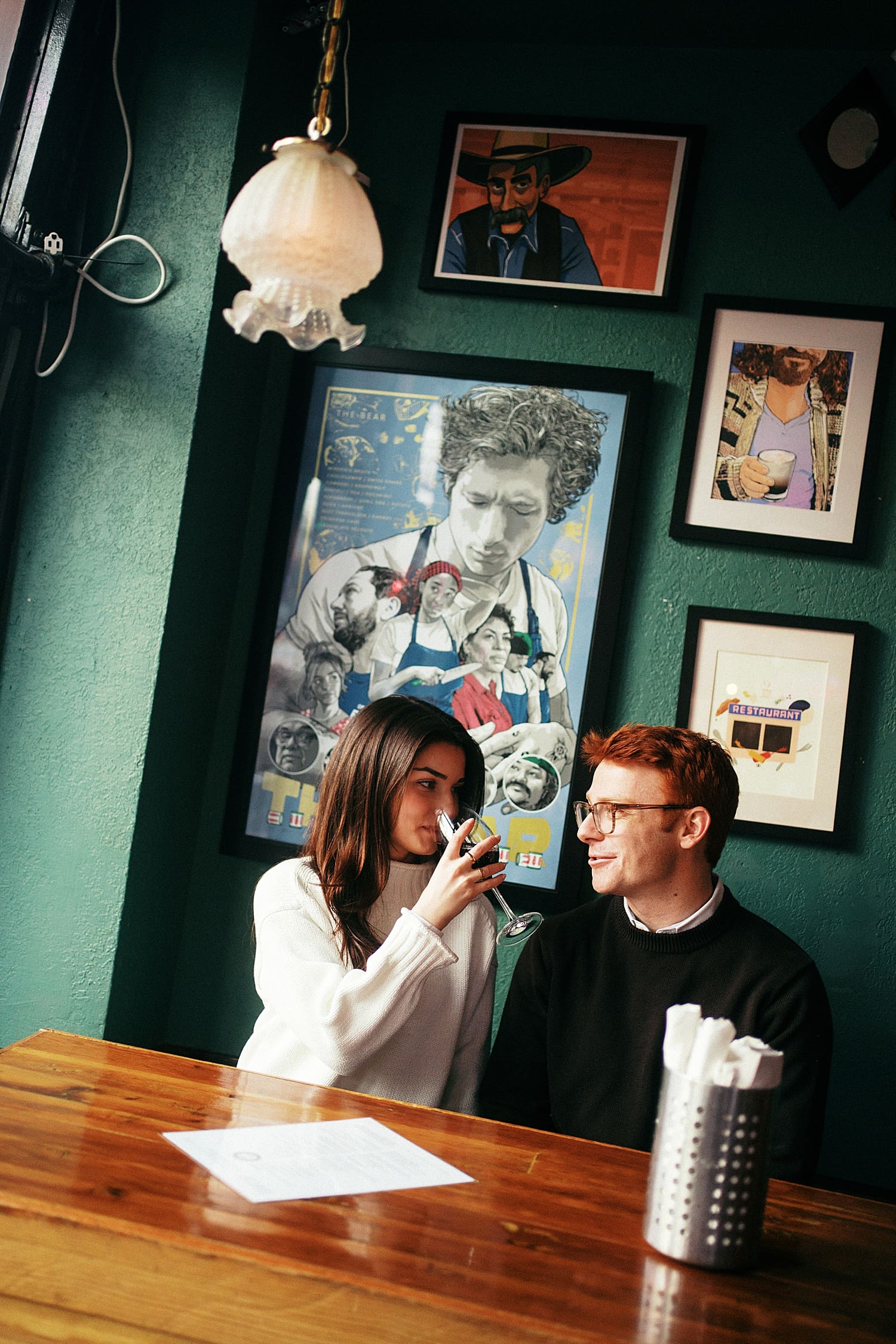 fiance drinks wine at table with her partner by St. Louis Wedding Photographer