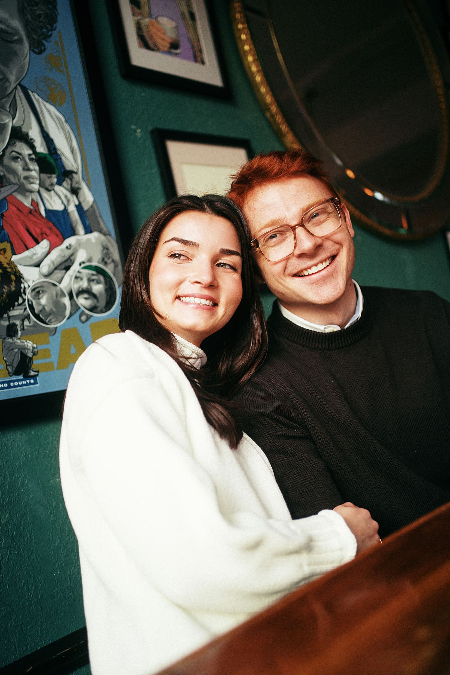 brunette snuggles her fiance at table by St. Louis Wedding Photographer