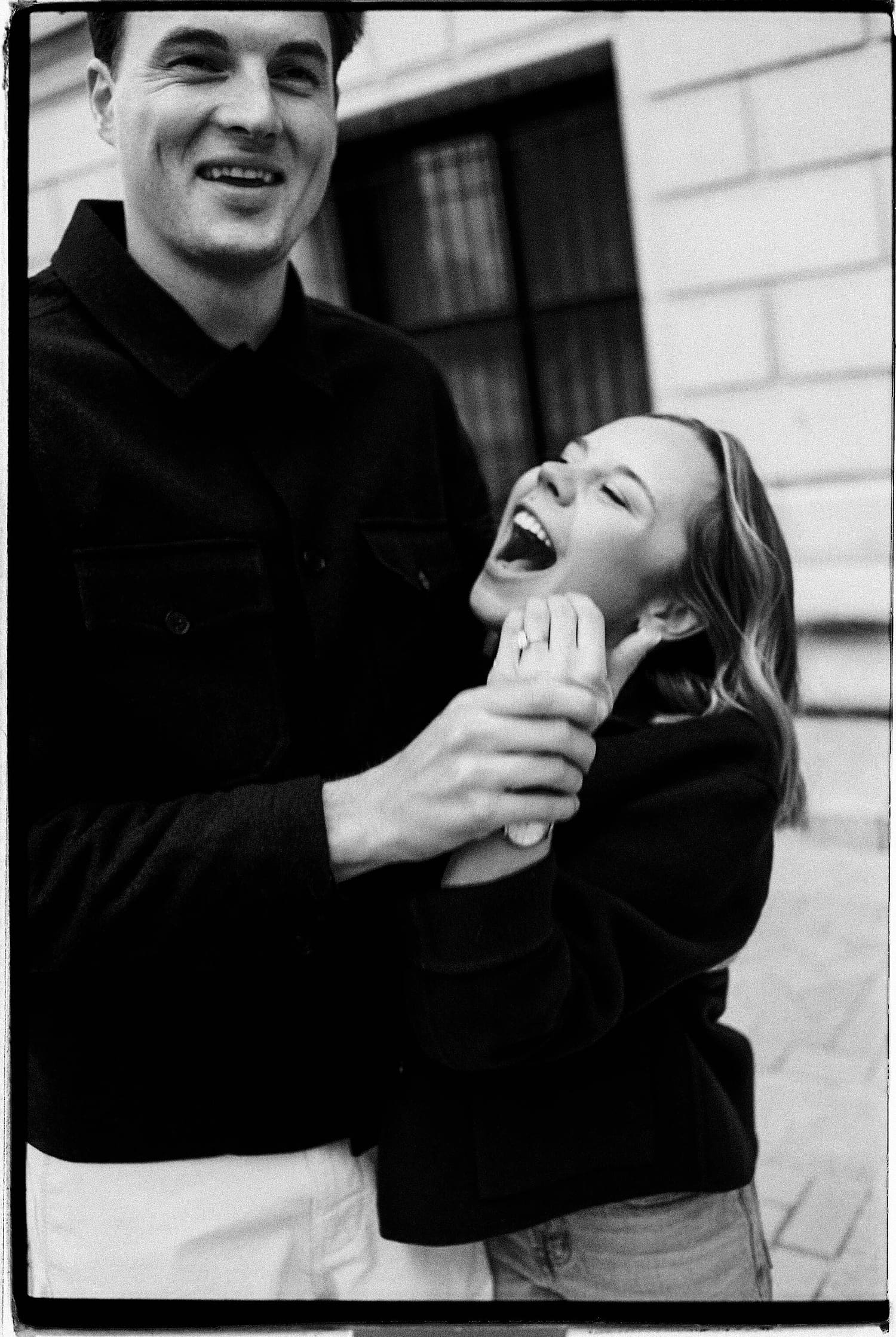 man and woman laughing after learning how to feel natural in engagement photos