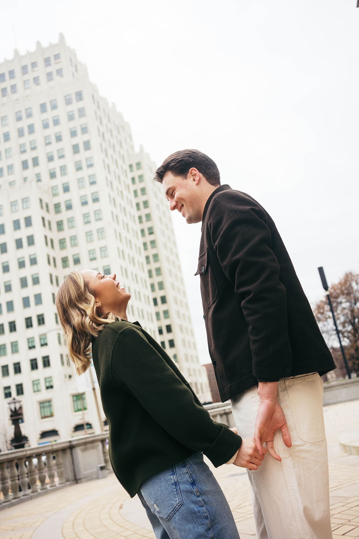 couple hold hands in the street after learning how to feel natural in engagement photos