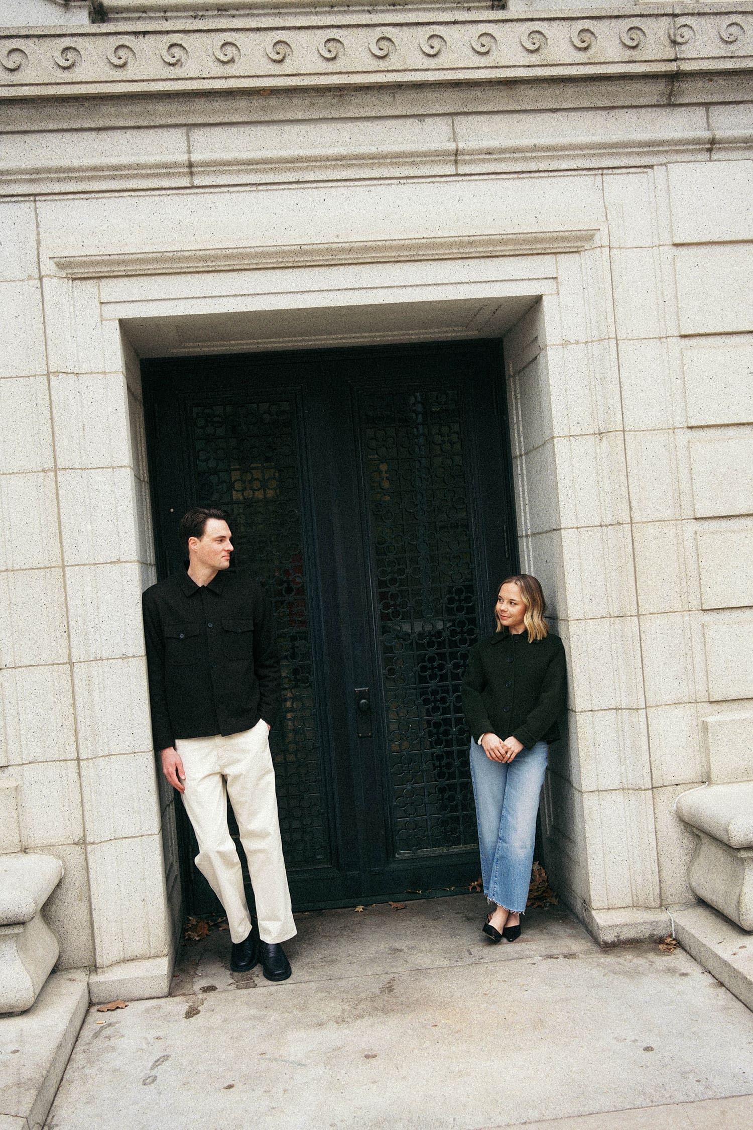 man and woman look at each other across a doorway by St. Louis wedding photographer