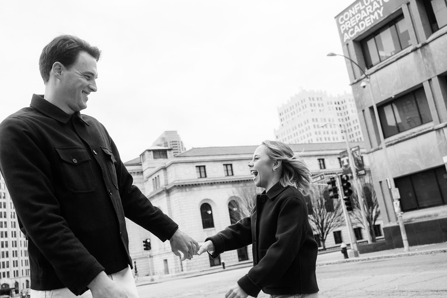 man and woman laughing together out on the city streets by Camille Meers Photography