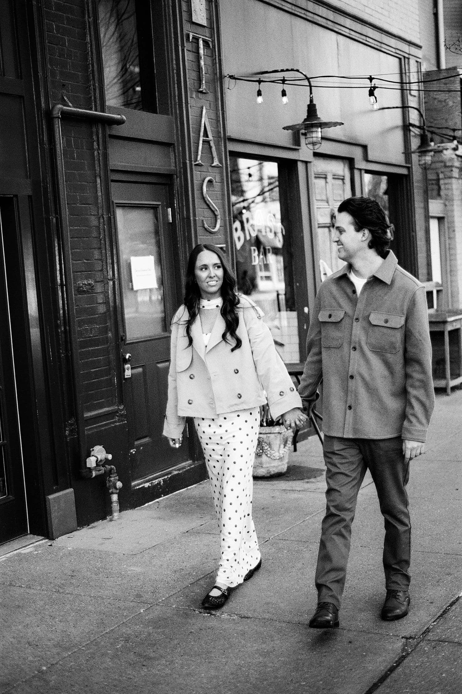 man and woman walk down sidewalk for photos that feel like date night