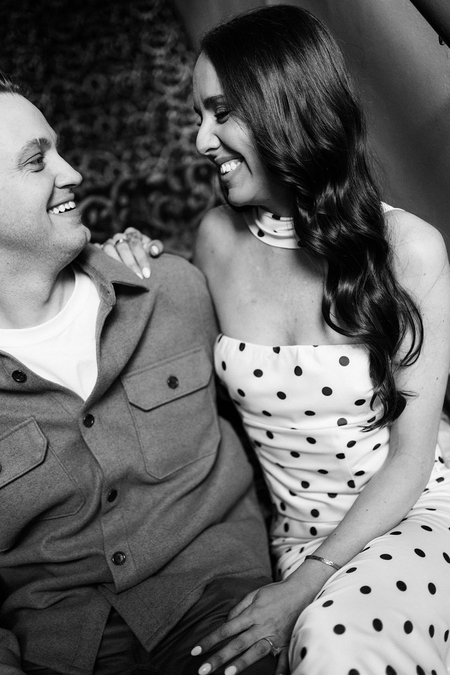 man and woman sit together laughing by Camille Meers Photography