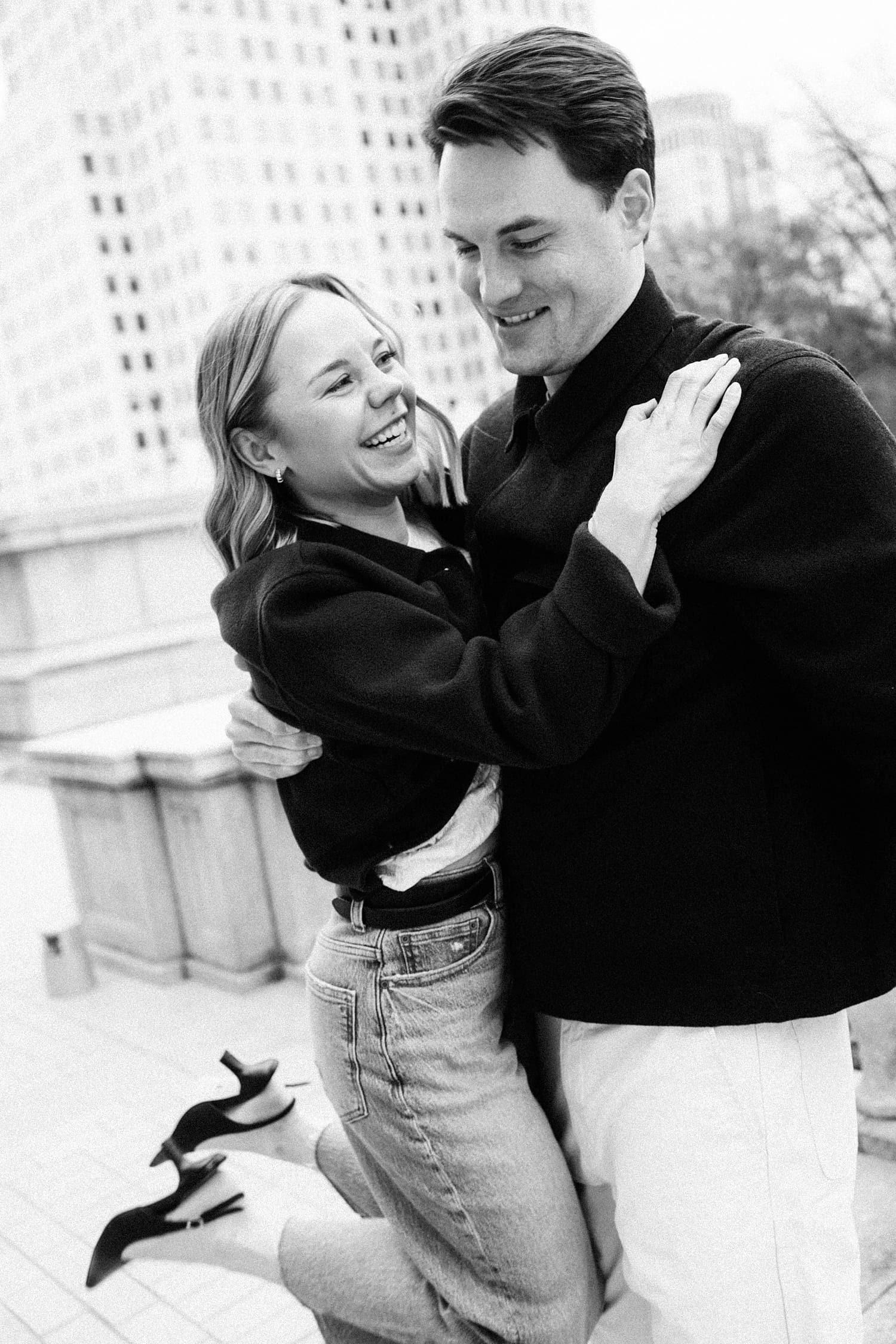 man holds up his fiance for a spin by St. Louis wedding photographer