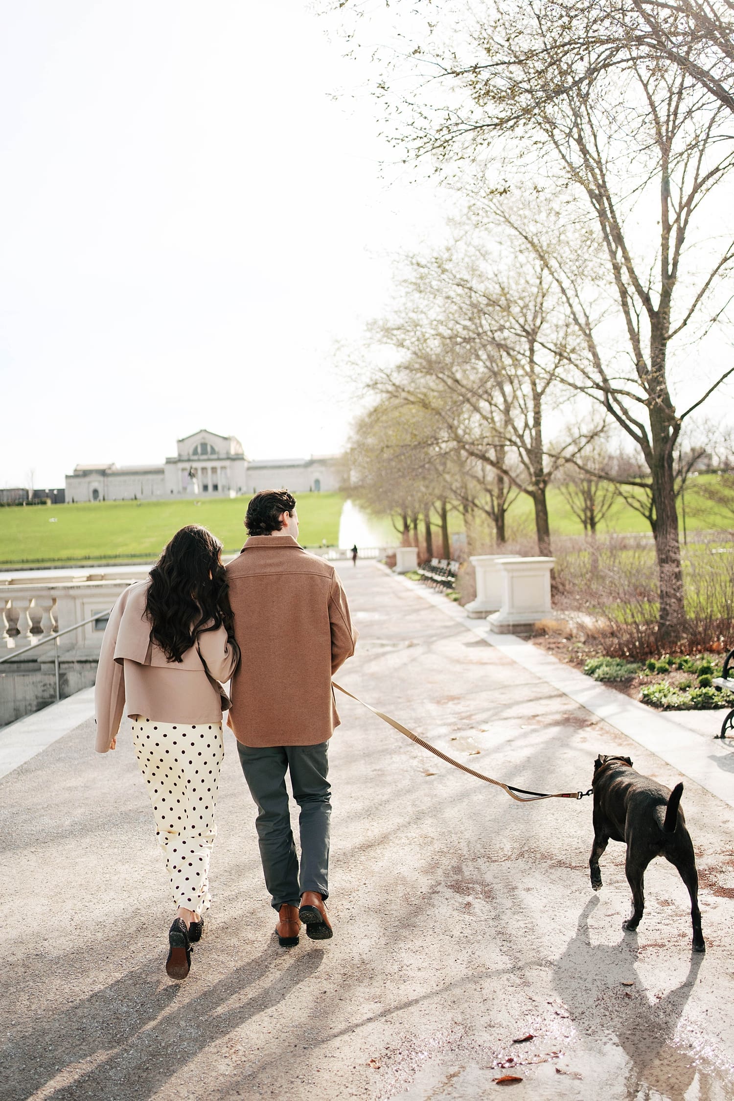 brunette woman leans on man's shoulder during walk in Forest Park by Camille Meers Photography