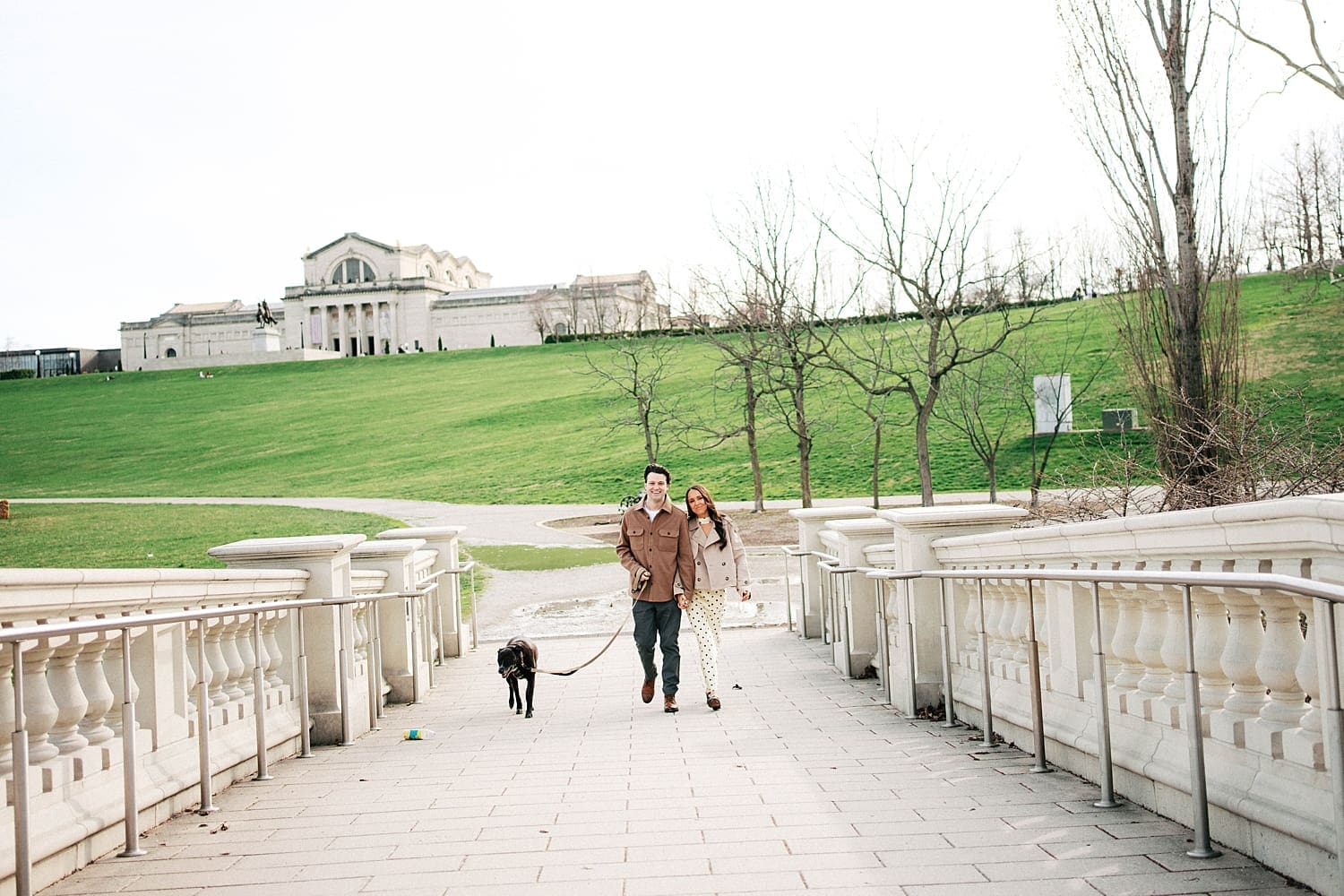 man and woman walk along a path in Forest Park by St. Louis wedding photographer