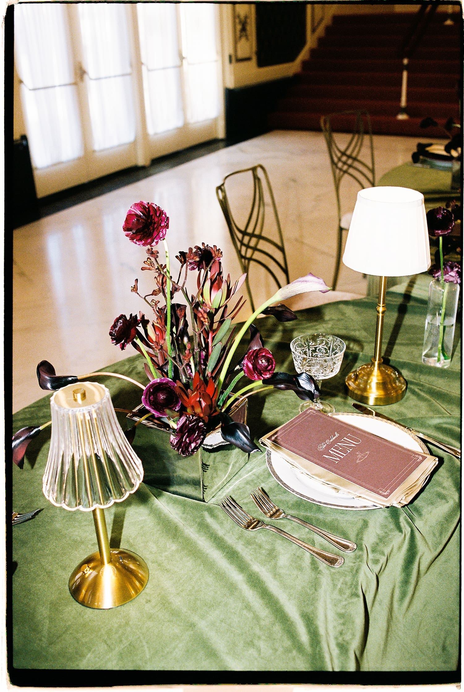 table spread with organic flowers and green tablecloth by Camille Meers Photography
