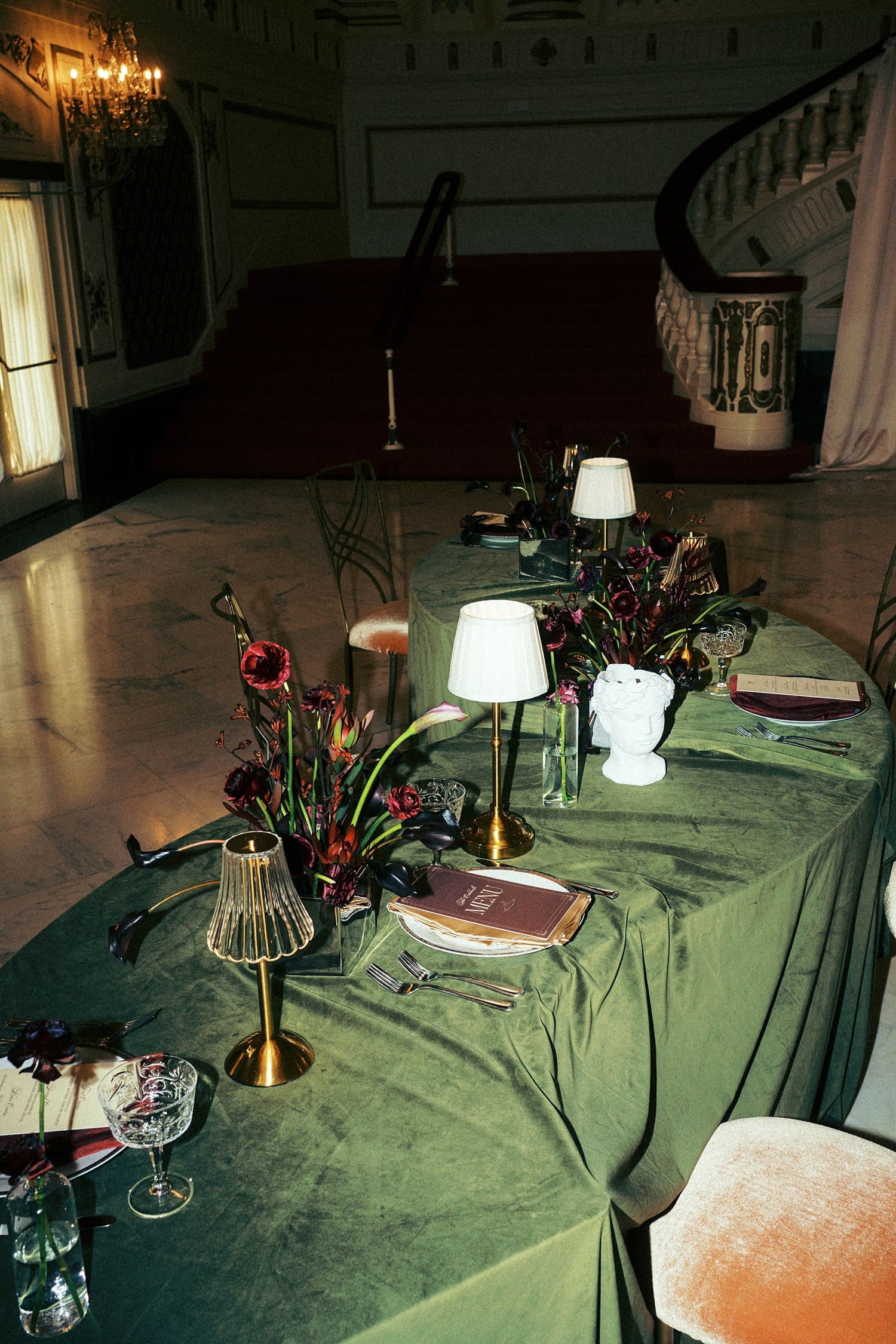 dinner table with green cloths and organic florals by St. Louis wedding photographer