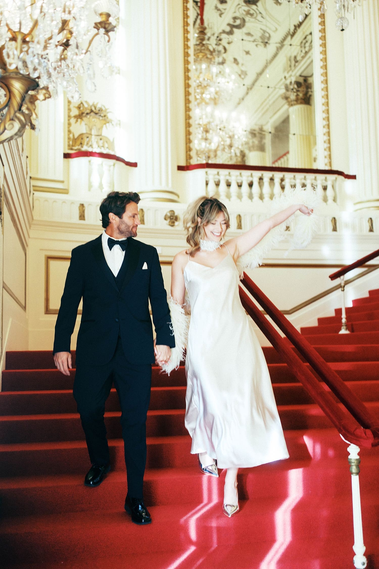 bride lifts her hand in celebration by Camille Meers Photography