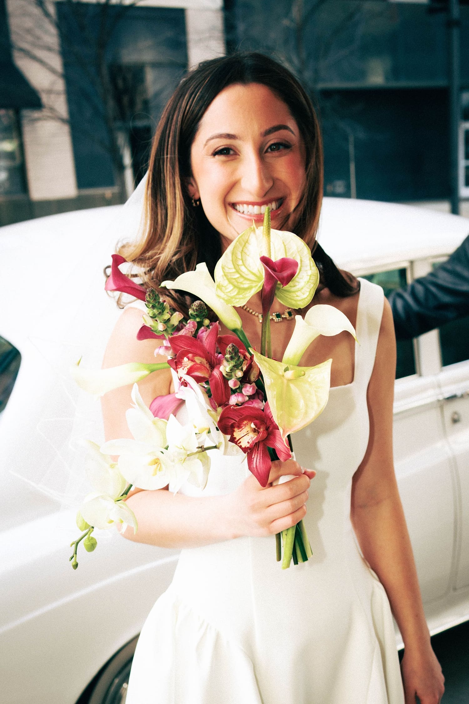 brunette woman with flowers in hand by Camille Meers Photography