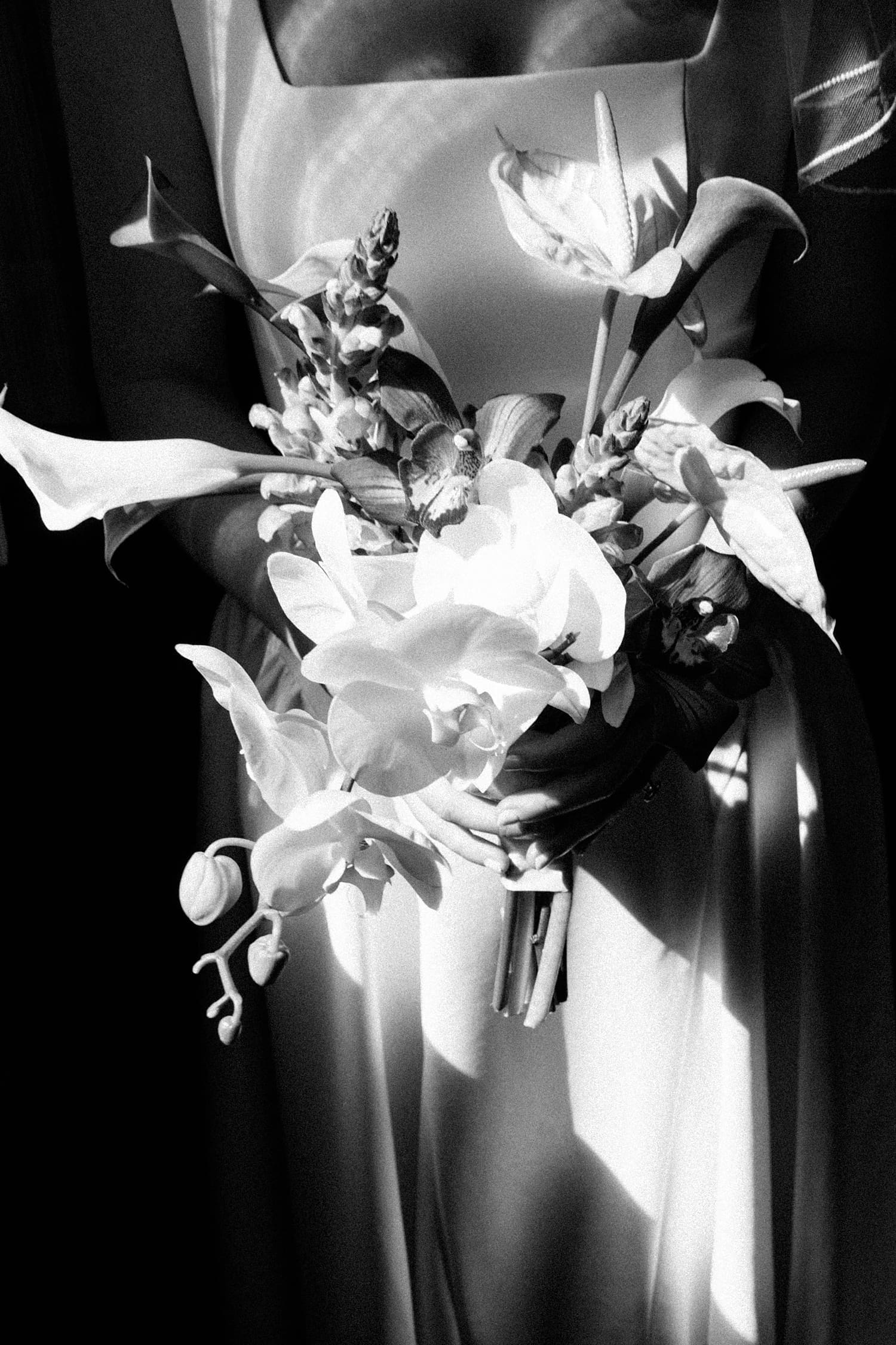 bride holds her simple bouquet of flowers by St. Louis Wedding Photographer