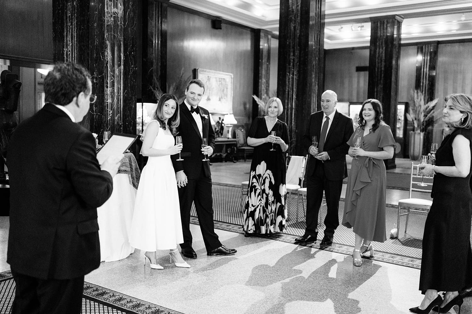 newlyweds listen to toasts by their guests by Camille Meers Photography