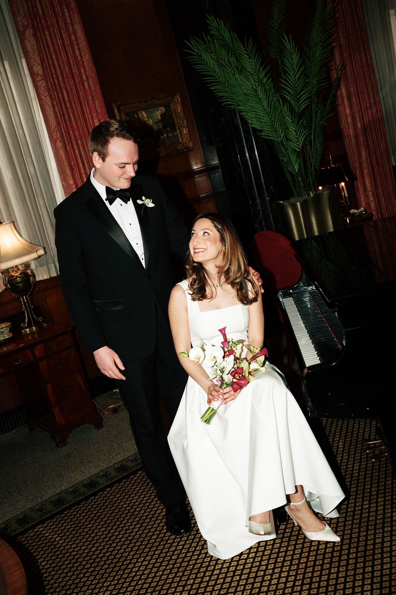 bride and groom sit in formal parlor at the Missouri Athletic Club