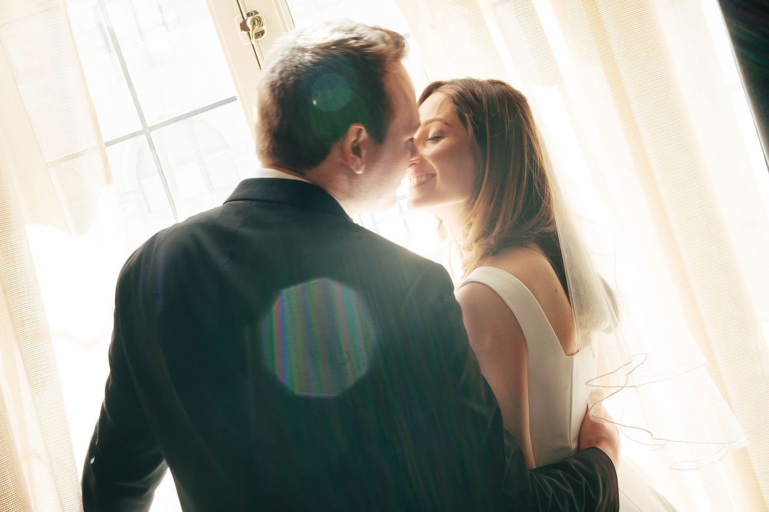 husband and wife lean in close for a kiss by Camille Meers Photography