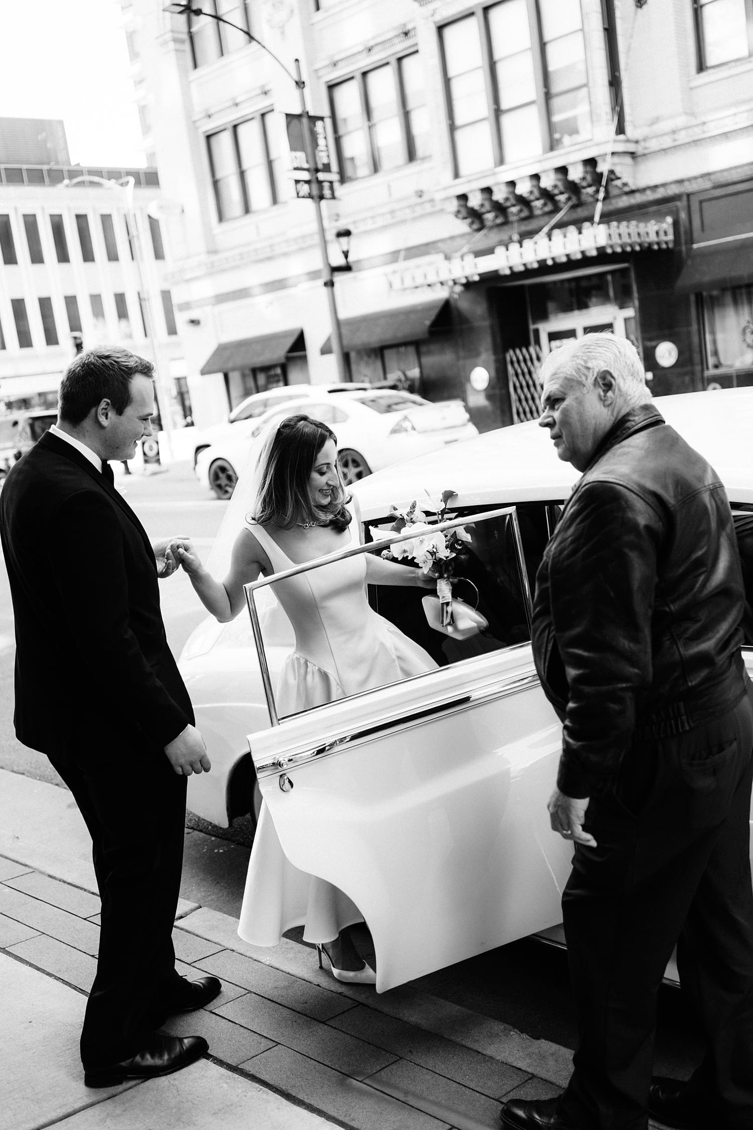 bride and groom get into old timey car by St. Louis Wedding Photographer