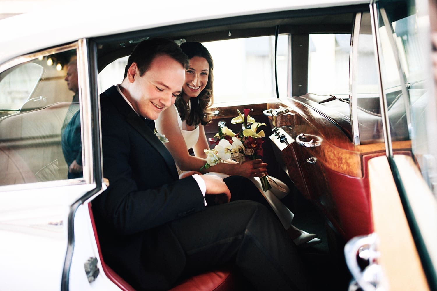 couple sits in the back of old vintage car by Camille Meers Photography