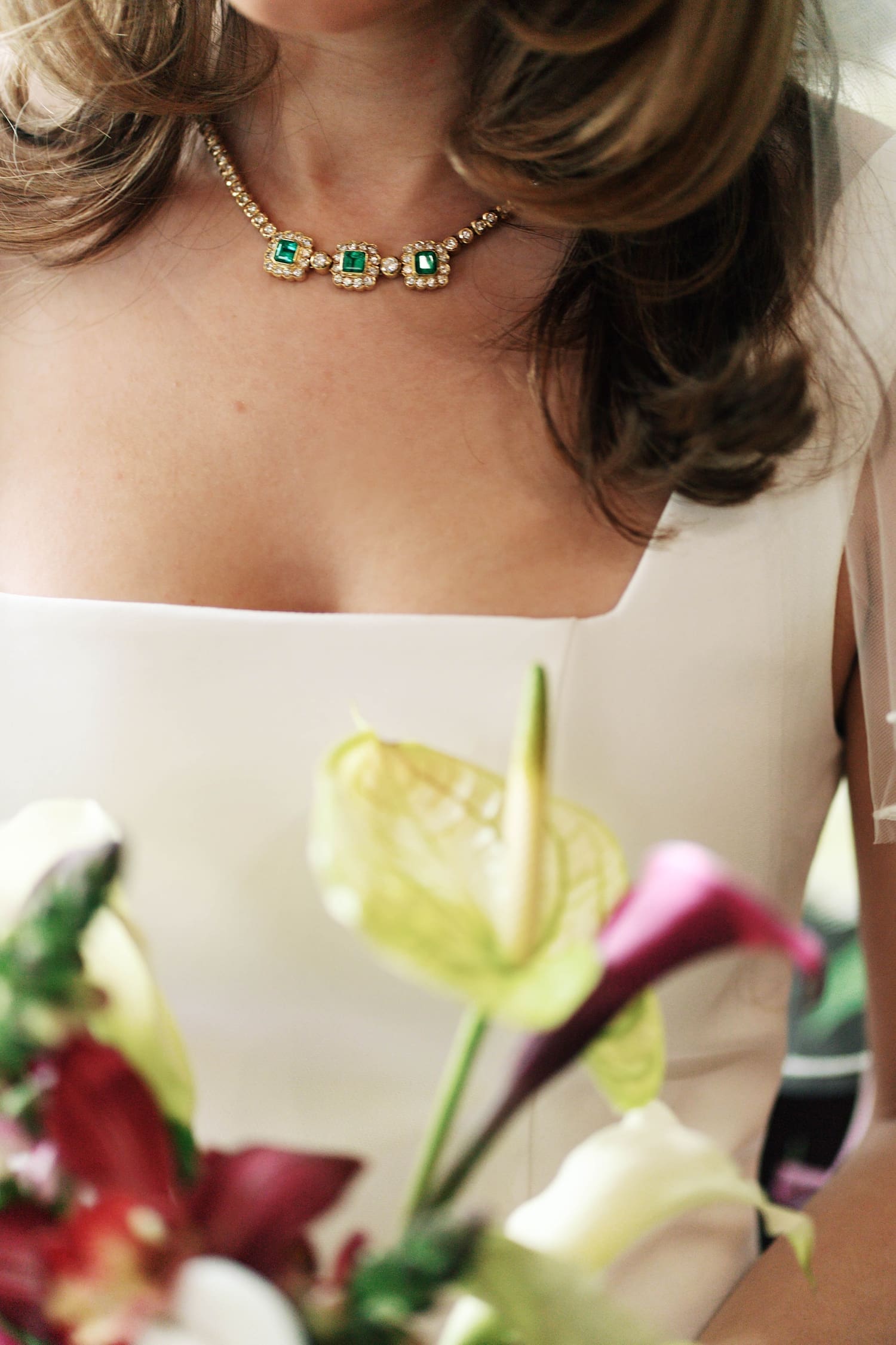 bride shows off her necklace with three emeralds by St. Louis Wedding Photographer