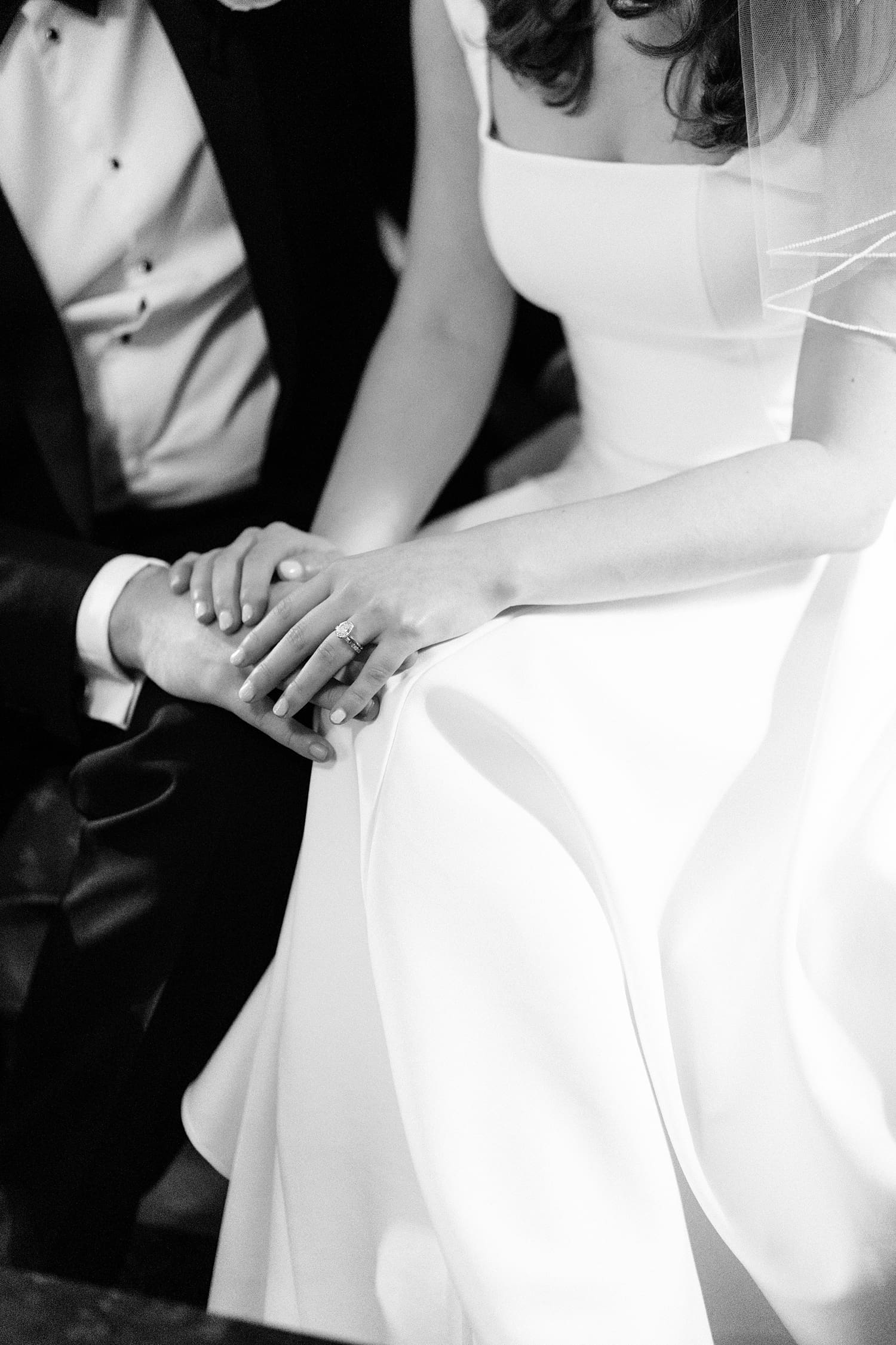 couple hold hands showing off a new diamond ring by Camille Meers Photography