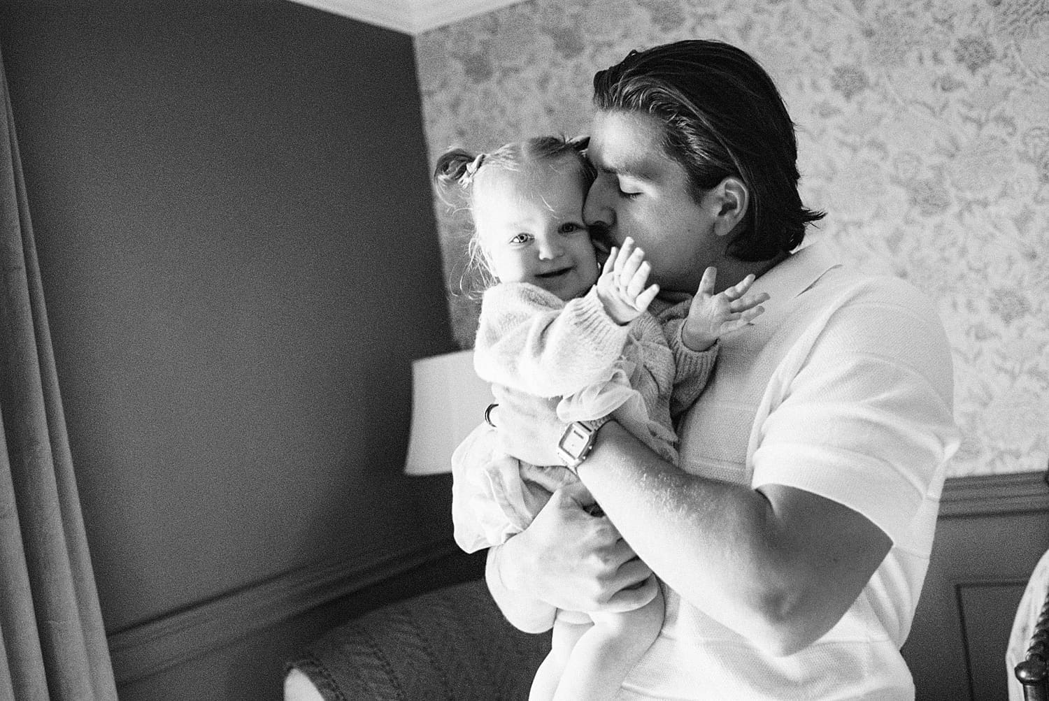 dad snuggles toddler for relaxed family session at home