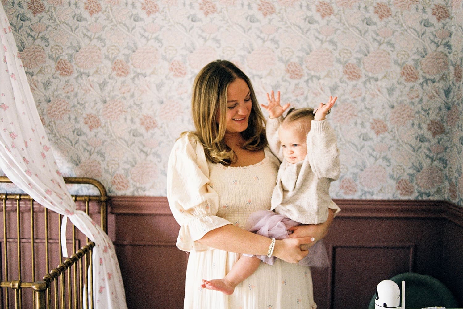 mother in white dress holds little girl by Camille Meers photography