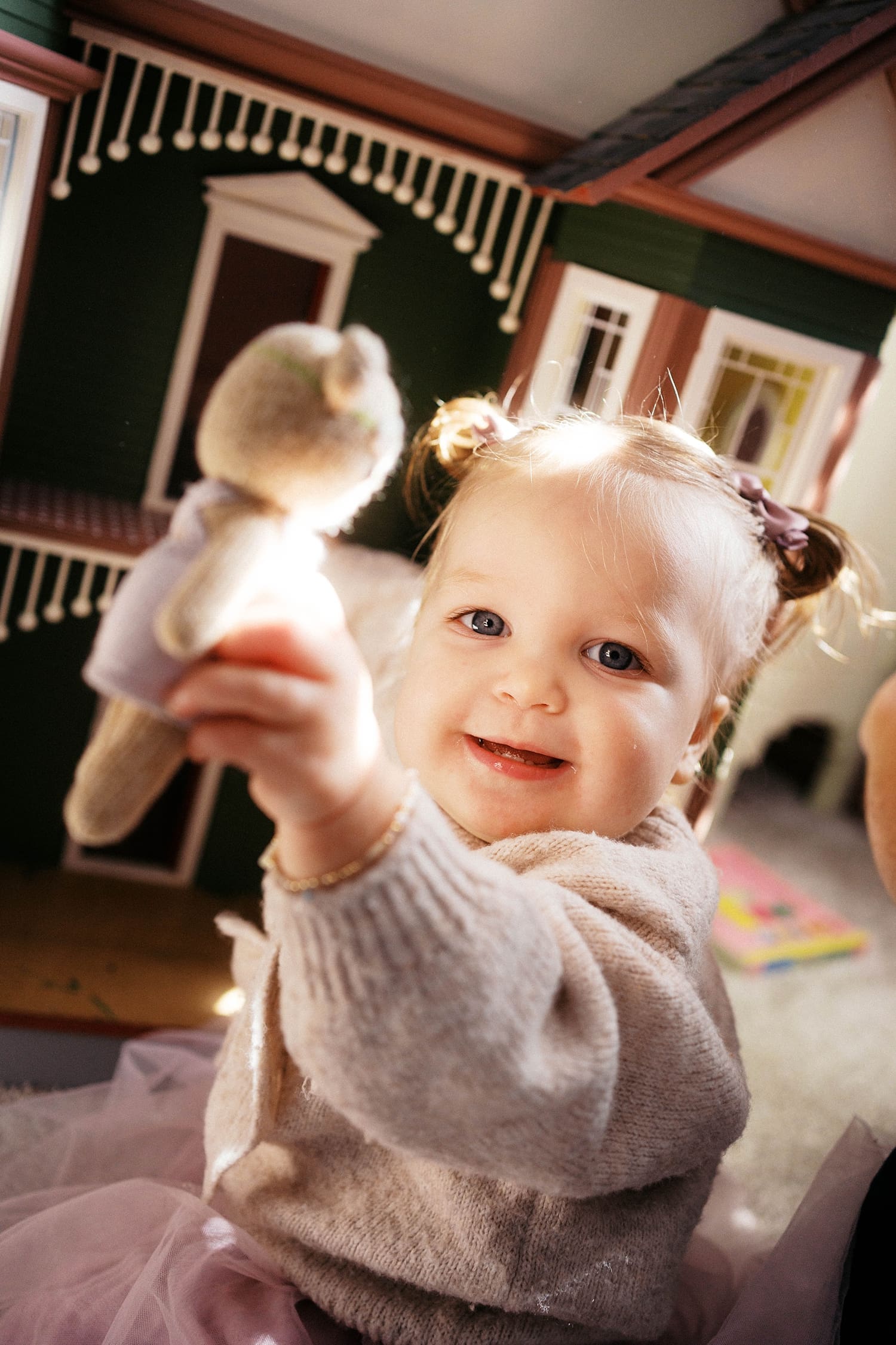 toddler holds up stuffie in living room by St. Louis film photographer