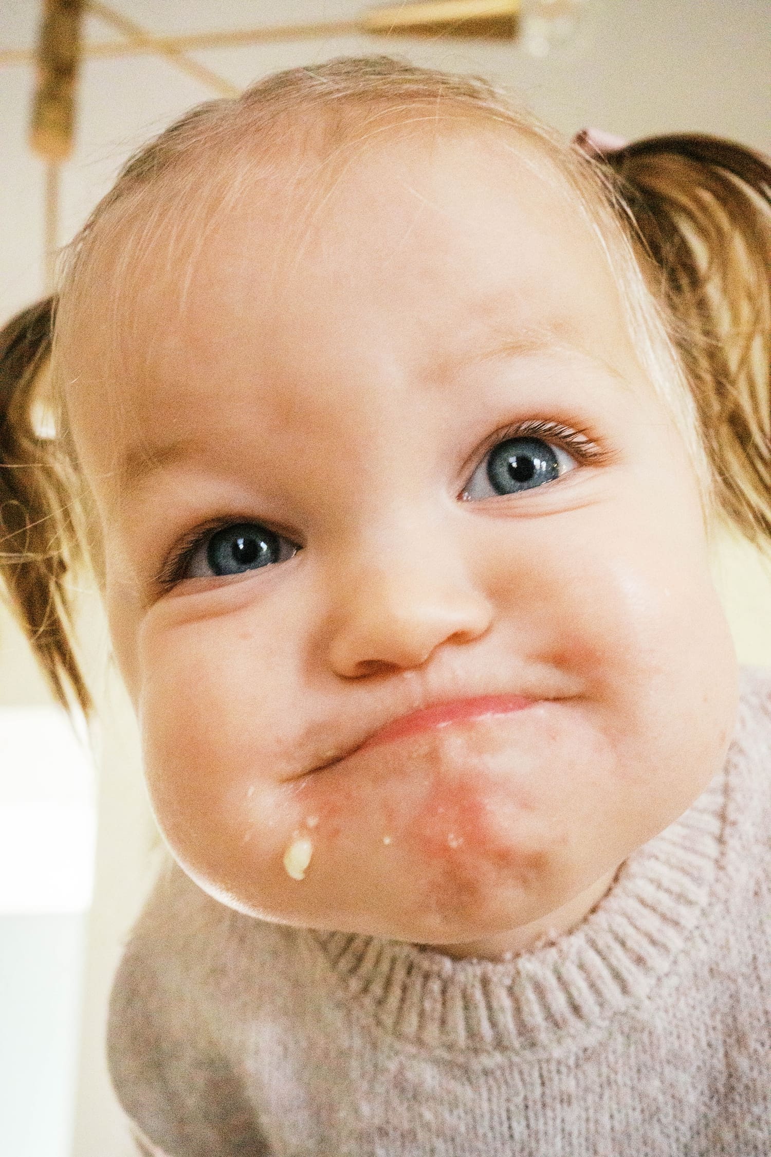 toddler smiles with food on her face by St. Louis film photographer