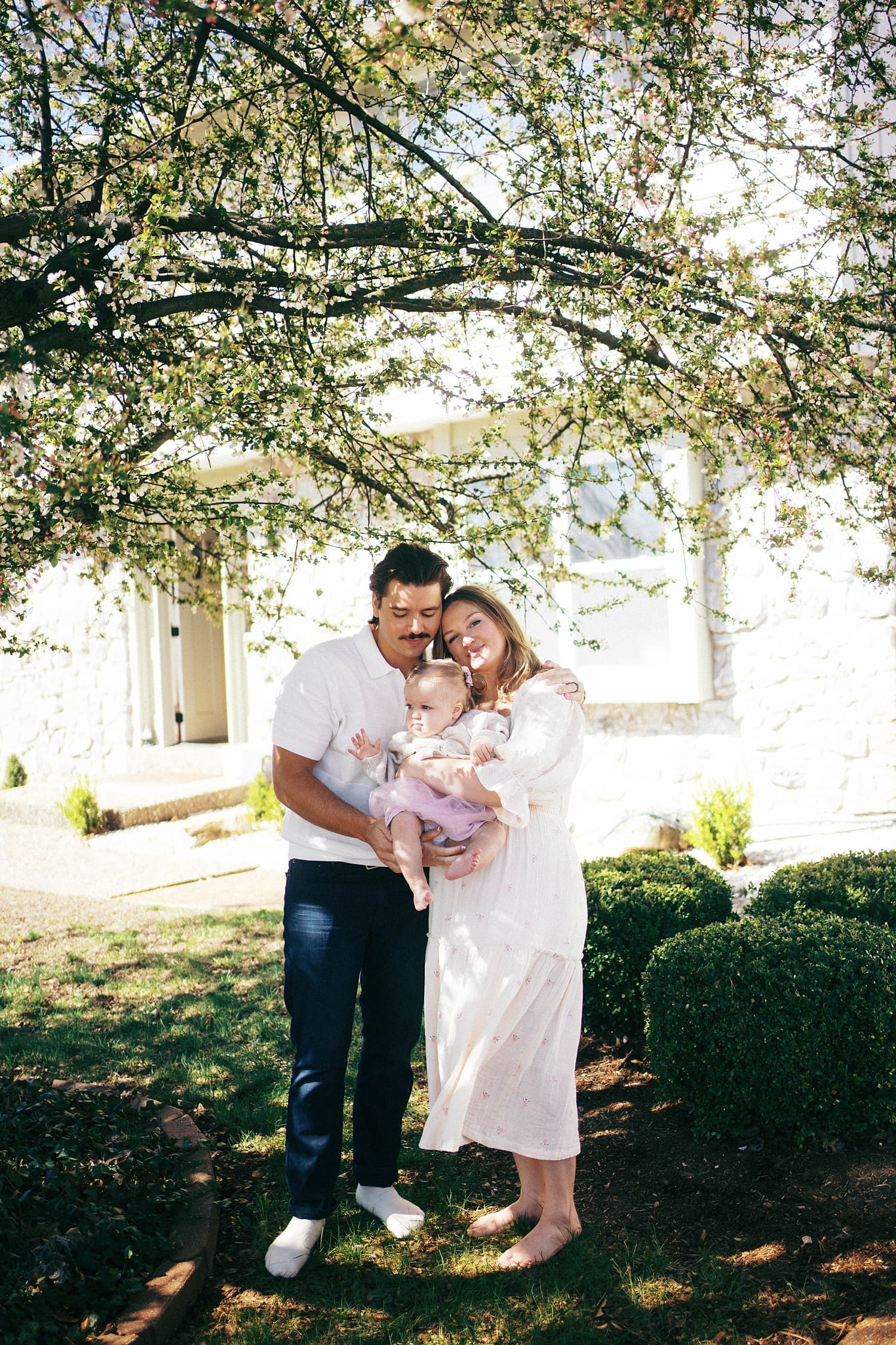 family of three stand under a tree by Camille Meers photography