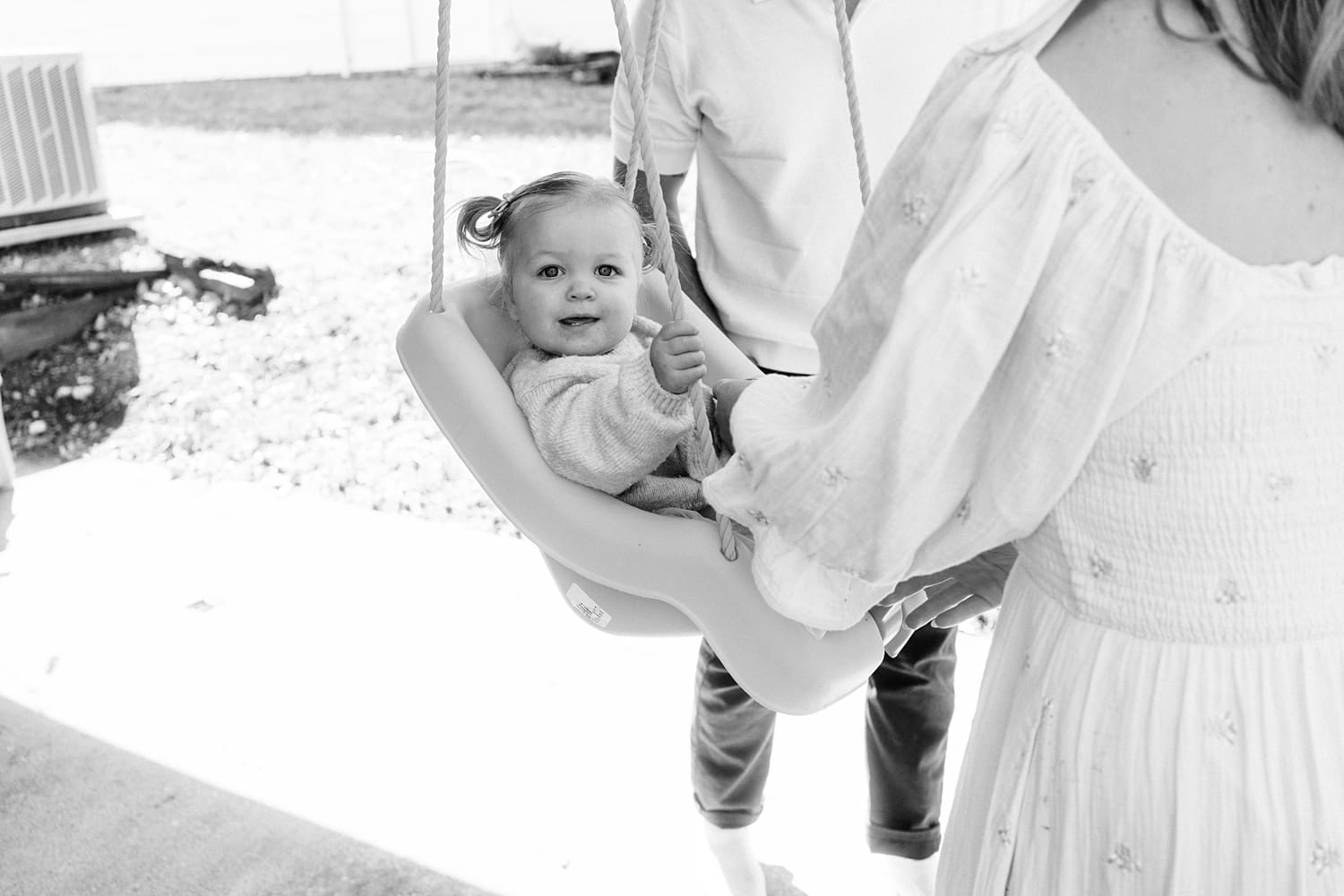 baby in a swing in front yard for relaxed family session at home