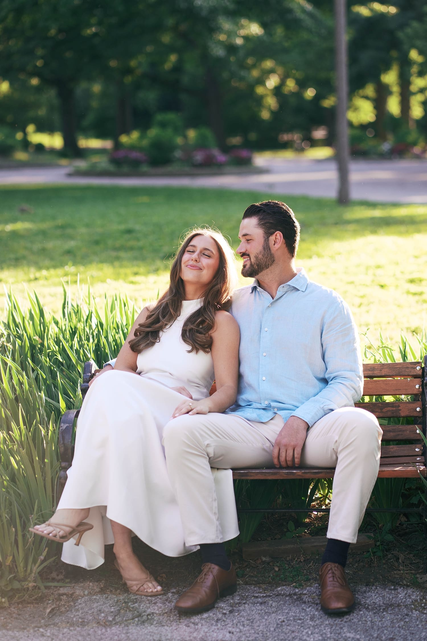 couple sit on park bench enjoying the sunshine by Camille Meers Photography