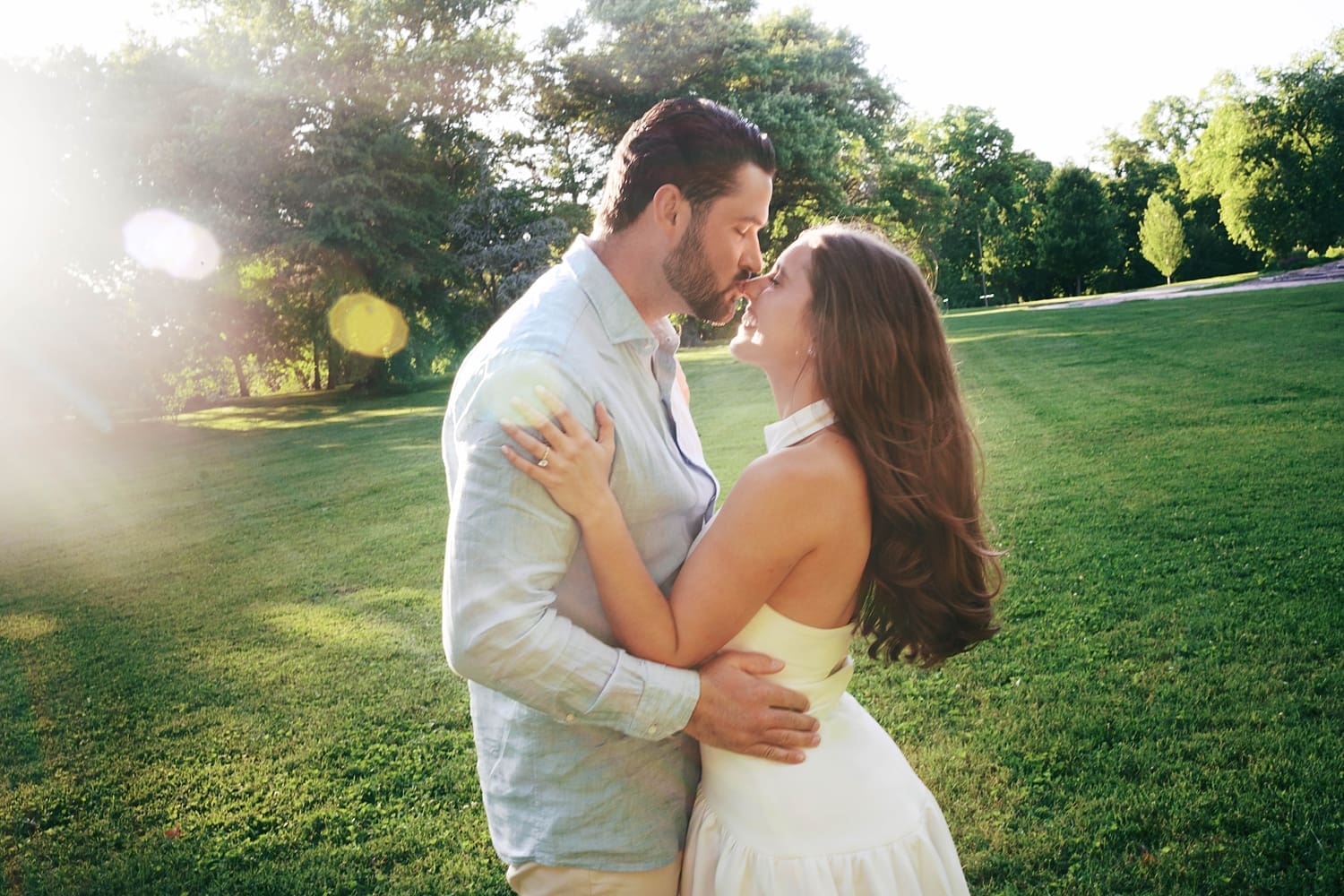 man leans in to kiss his fiance for unposed engagement session