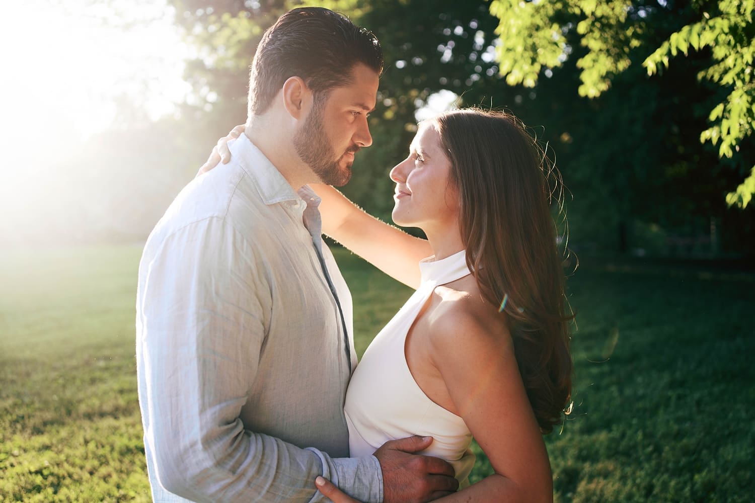 engaged couple hold each other and look fondly at each other's eyes by Camille Meers Photography