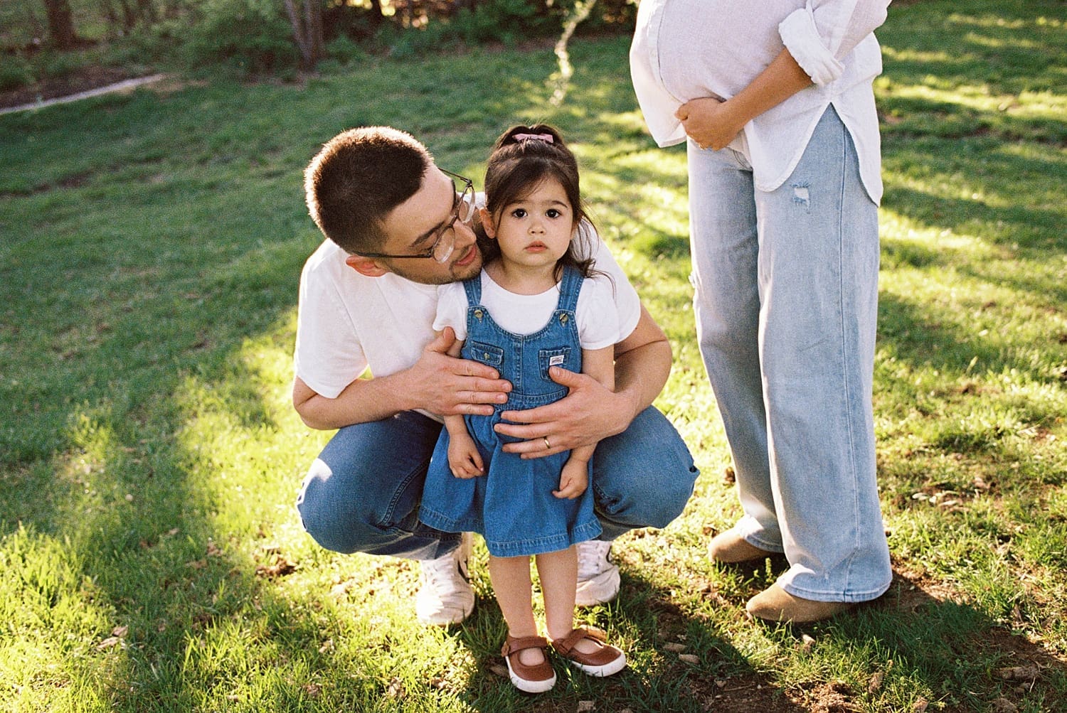 toddler in overall dress in lawn for candid maternity photo session