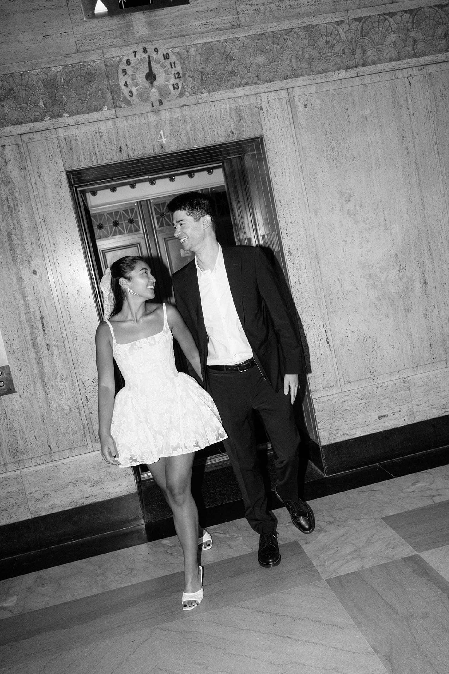 couple exit the elevator together after saying I Do by Camille Meers Photography