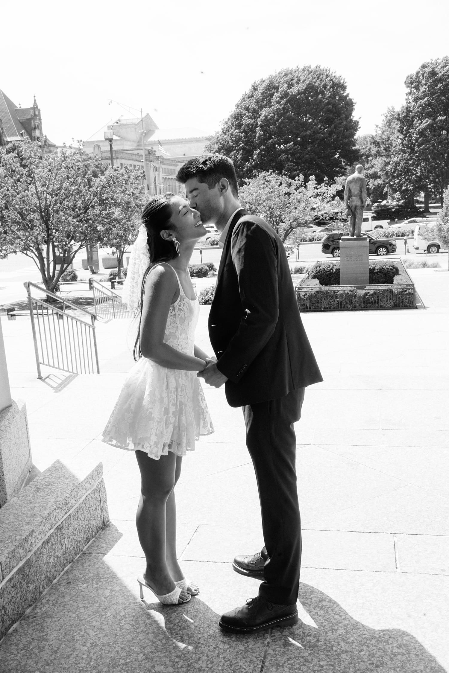 man leans in to kiss his new bride by Camille Meers Photography