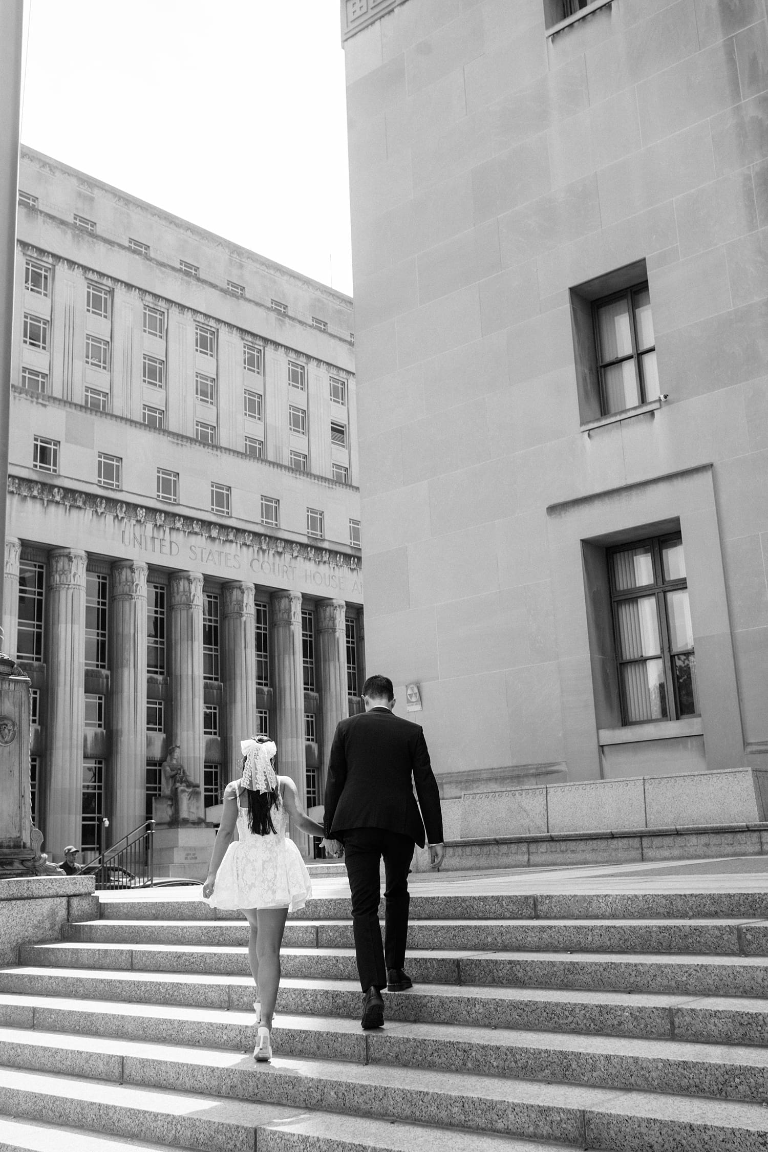 couple walk up the steps after eloping by Camille Meers Photography