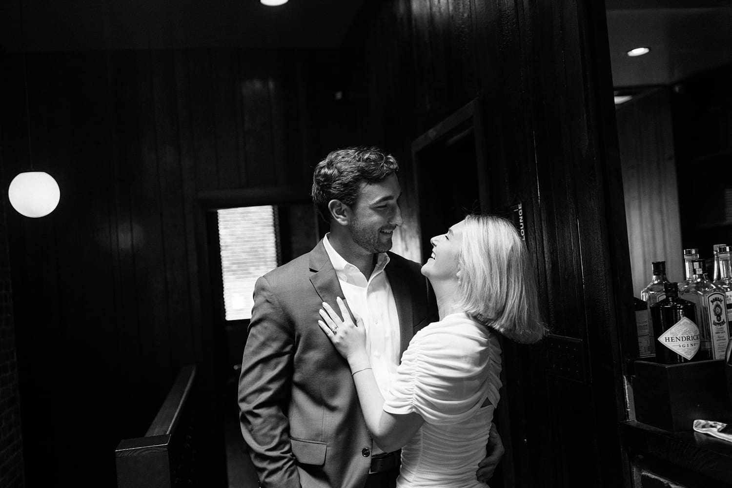 couples gaze at each other in dark hallway at Brennan's in Central West End