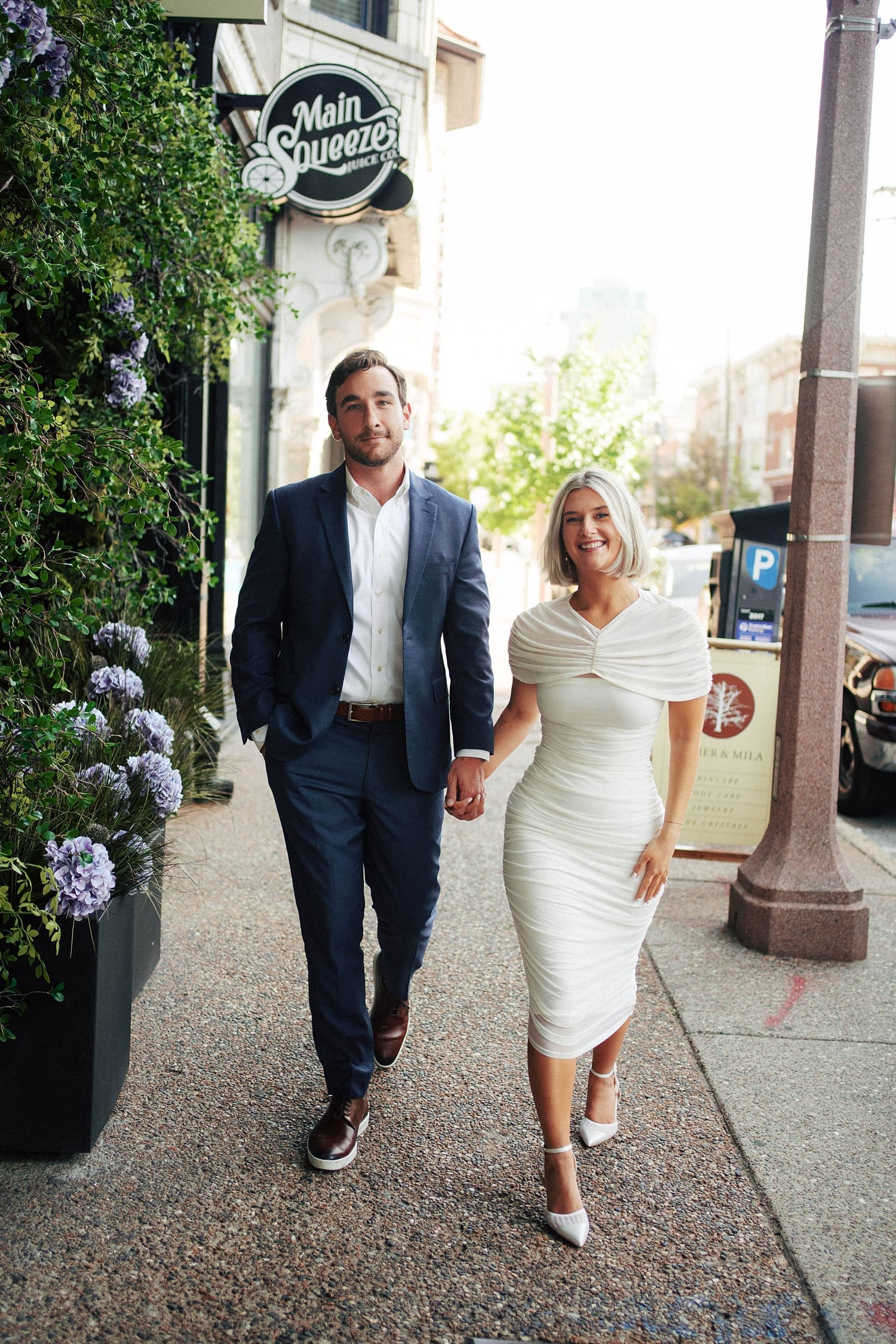 engaged couple walk down old sidewalk by St. Louis wedding photographer