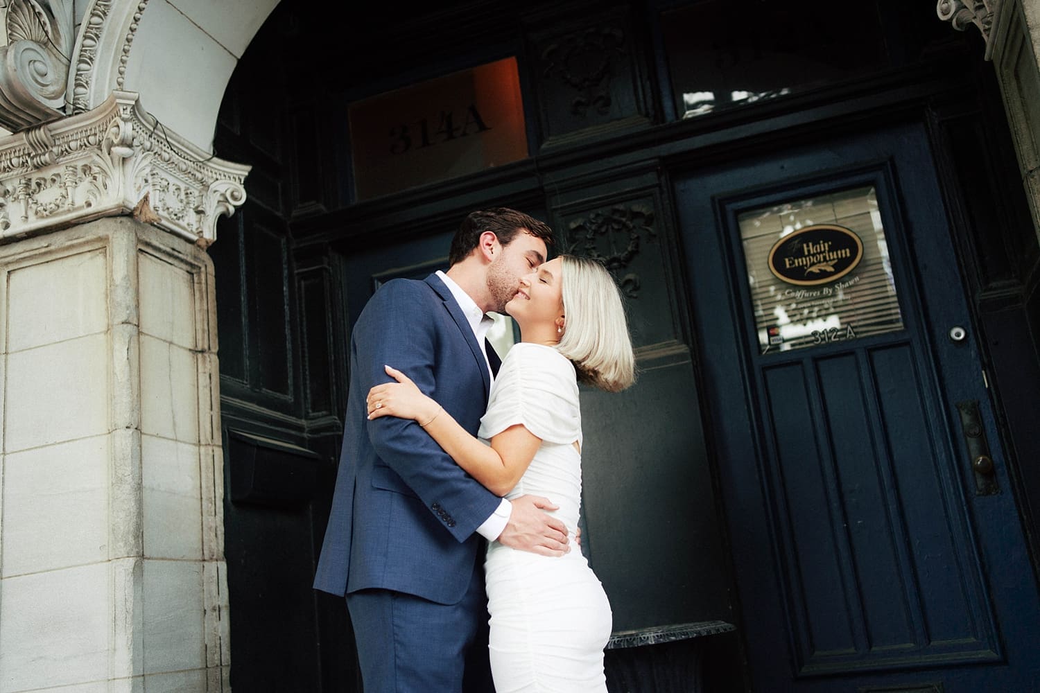 man kisses his bride to be outside Brennan's in Central West End