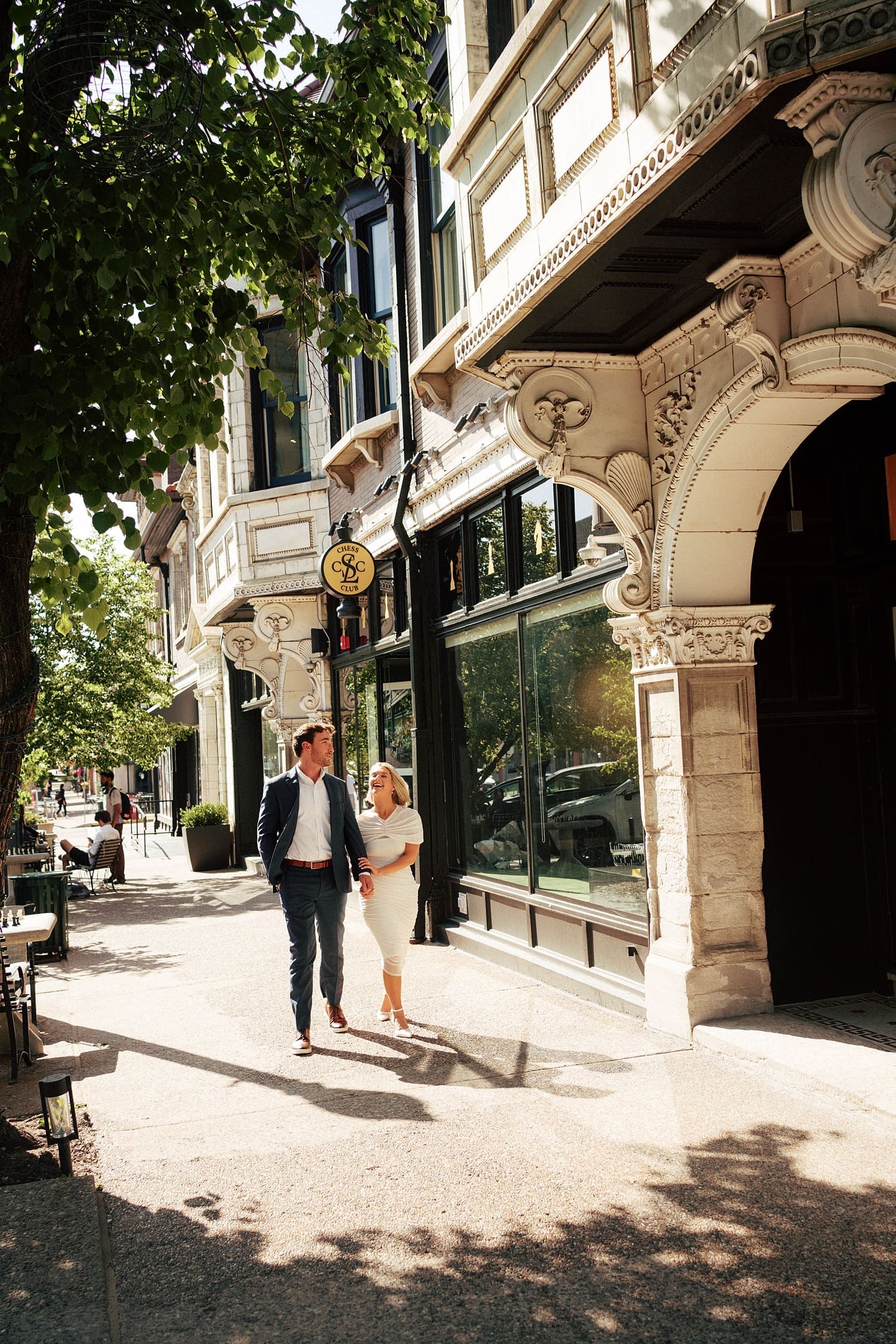 couple walk hand in hand down historic street by St. Louis wedding photographer
